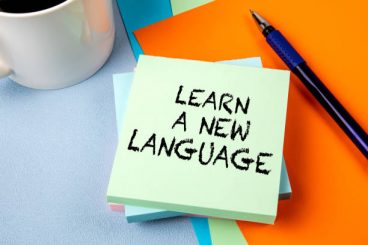 Home learn a new language. notepad with text on office table.